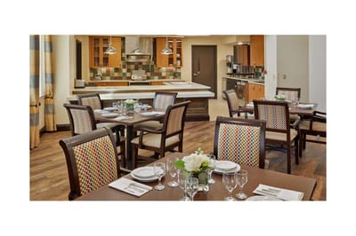 Dining room setup with plates and floral centerpieces