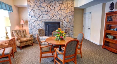 Cozy common area with a fireplace and floral centerpiece