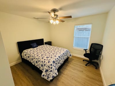 Cozy bedroom with a floral-patterned bedspread and chair
