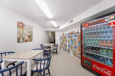 Bright common area with seating and vending machine