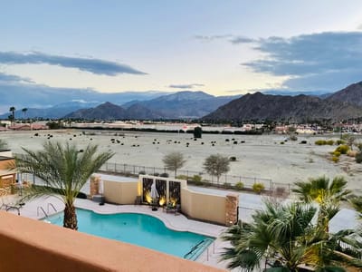 Outdoor pool area with mountains in the background