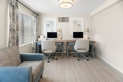 Modern interior workspace with computers and seating