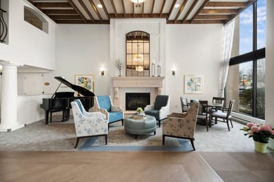 Bright and inviting common area with seating and piano