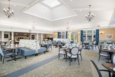 Spacious dining room with floral decor and natural light
