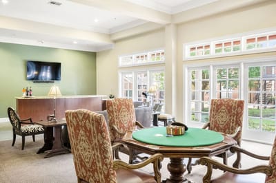 Interior of a common area with a card table and lounge seating