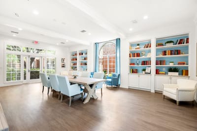 Bright, inviting common area with bookshelves and seating