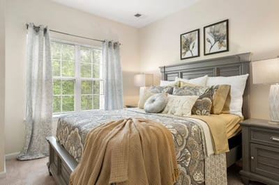 Cozy bedroom setup with decorative pillows and blankets
