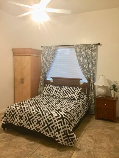 Cozy private resident bedroom with patterned bedding