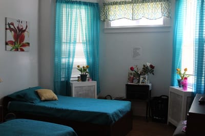 A bright shared bedroom in a senior care facility