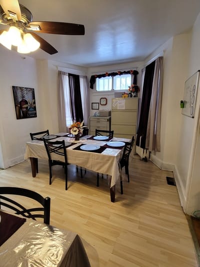 Dining area with a set table and bright windows