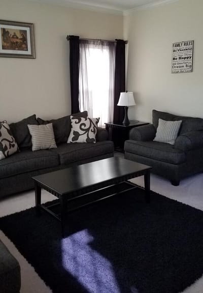 Cozy common area with gray sofas and a lamp