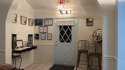 Interior lobby area with a blue door and seating