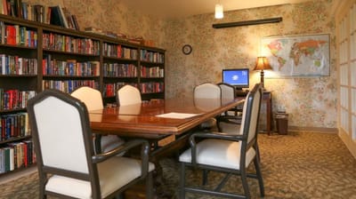 Cozy common area with bookshelves and a meeting table