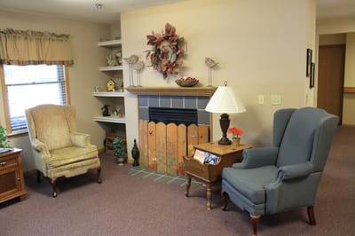 Cozy sitting area with two chairs and a fireplace
