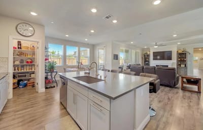 Interior view of a spacious common area with kitchen and living space