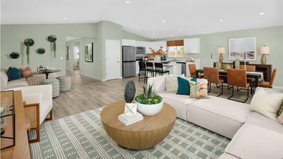 Bright common area with seating and kitchen visible