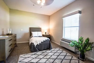 Private resident room with bed and natural light