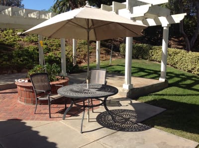 Outdoor seating area with shaded table and chairs