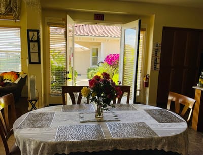 Bright dining area with a view of flowers outside