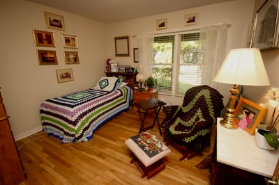Cozy resident room with a colorful blanket and decor