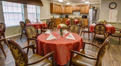 Brightly decorated dining room with round tables