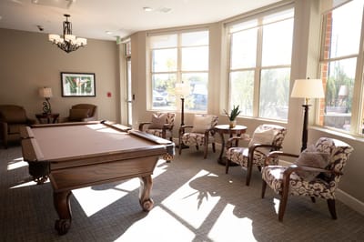 Bright common area with pool table and seating