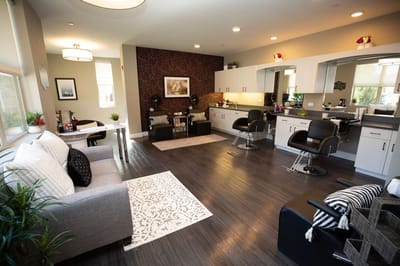 Bright salon area with comfortable seating and styling stations