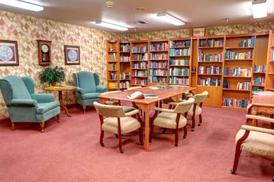 A cozy library area with bookshelves and seating