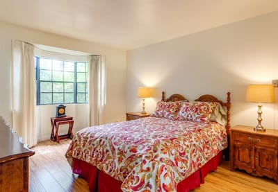 Cozy resident room with floral bedding and natural light