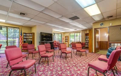 Interior view of a common area with red chairs