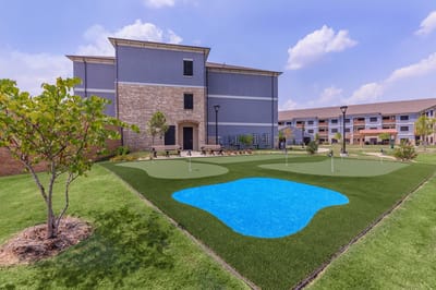 Outdoor putting green area beside the facility