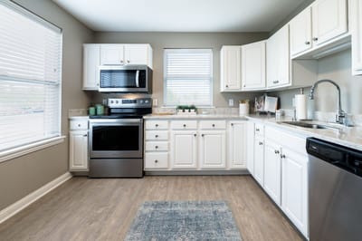Modern kitchen interior with white cabinets and appliances