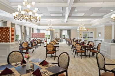 Bright, elegant dining room with tables set for meals