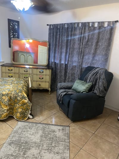 Cozy resident room with a chair and dresser