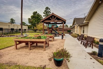 Outdoor gardening area with raised beds and seating