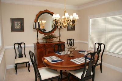 Bright dining room with a wooden table and chandelier