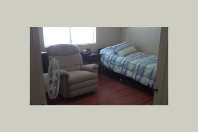 Private bedroom with a chair and bed in a nursing home