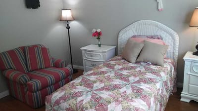 Cozy resident room with a bed and chair