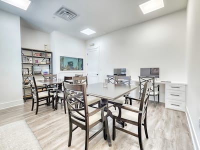 Interior of a bright common area with tables and chairs