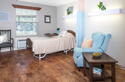Cozy resident room with bed and chair