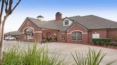 Exterior view of a senior living facility with landscaping