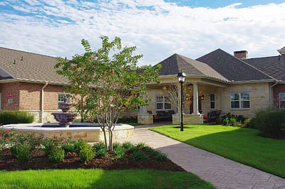 Exterior view of a nursing home with landscaping