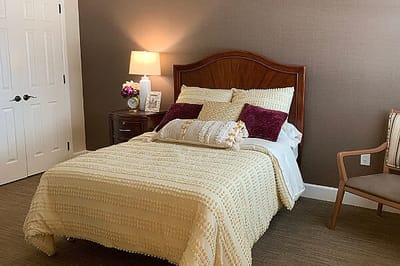 Cozy resident room with bed and chair