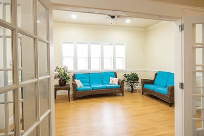 Bright common area with teal sofas