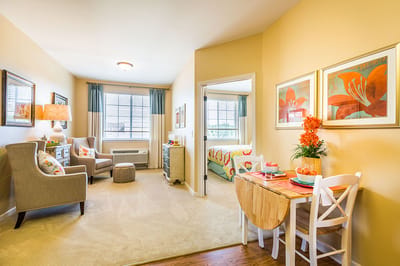 Brightly decorated resident room with cozy seating