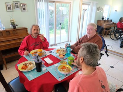 Residents enjoying a meal together in the dining room