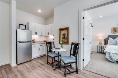 Cozy resident room with kitchenette and seating area