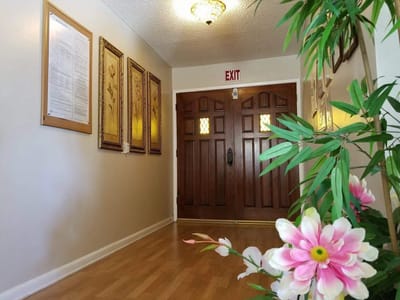 Interior hallway with flowers and wooden doors