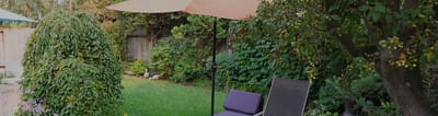 A peaceful garden area with chairs and umbrellas