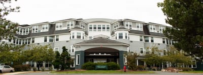 Exterior view of a senior living facility with landscaping